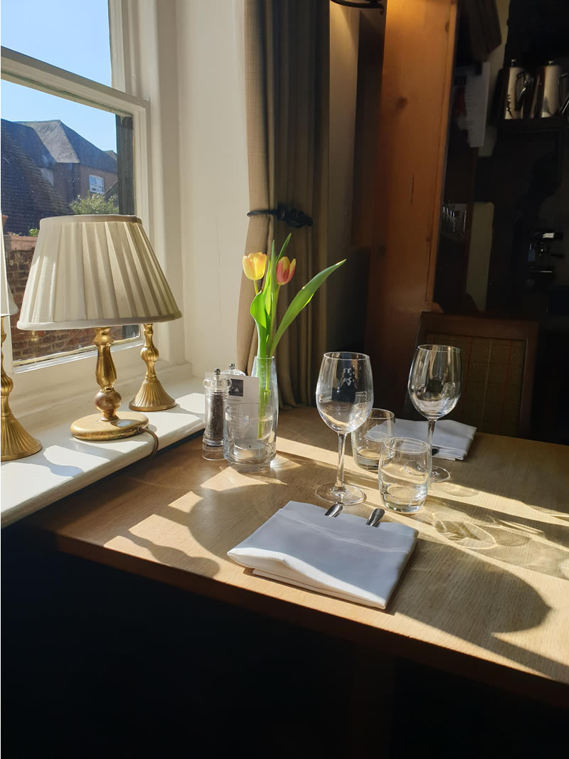 Elegantly dressed table next to a window at Ye Olde George Inn